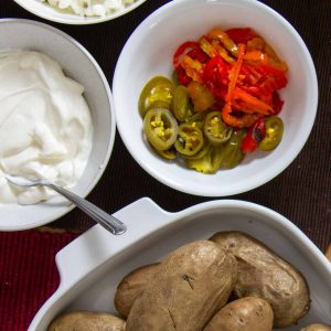 baked potatoes with toppings in bowls