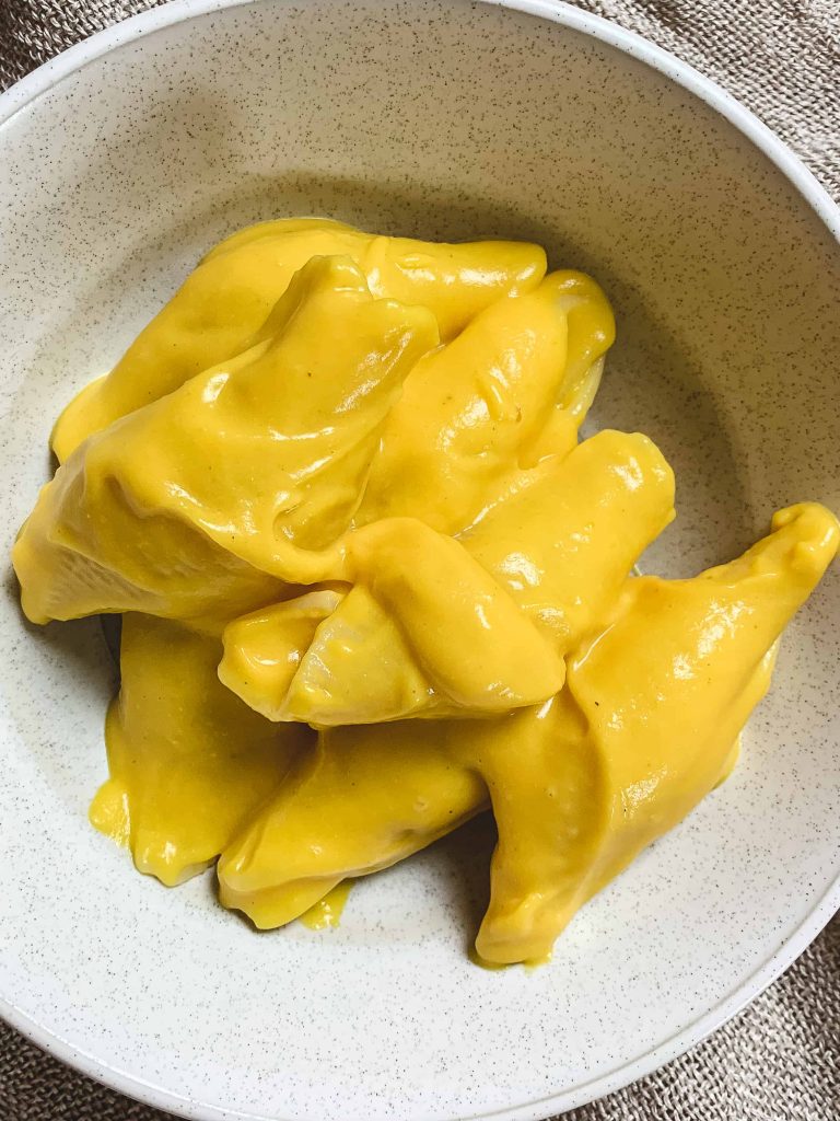 close up of cheesy butternut squash pasta in a bowl.