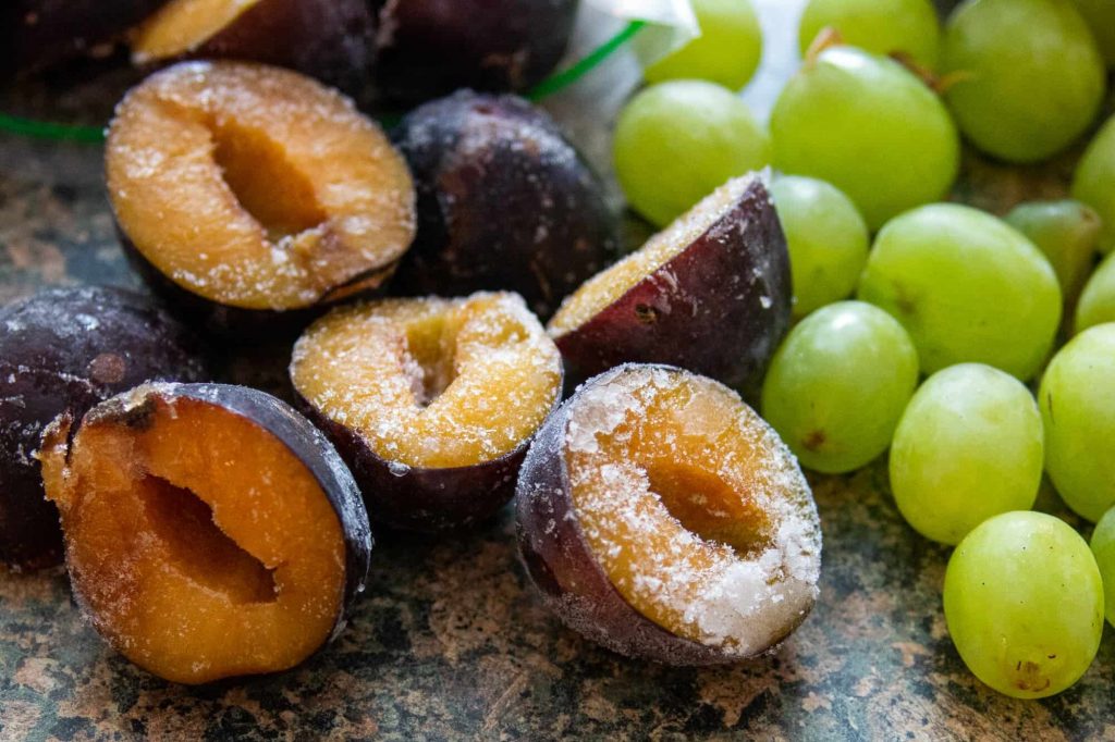 Frozen plums and grapes