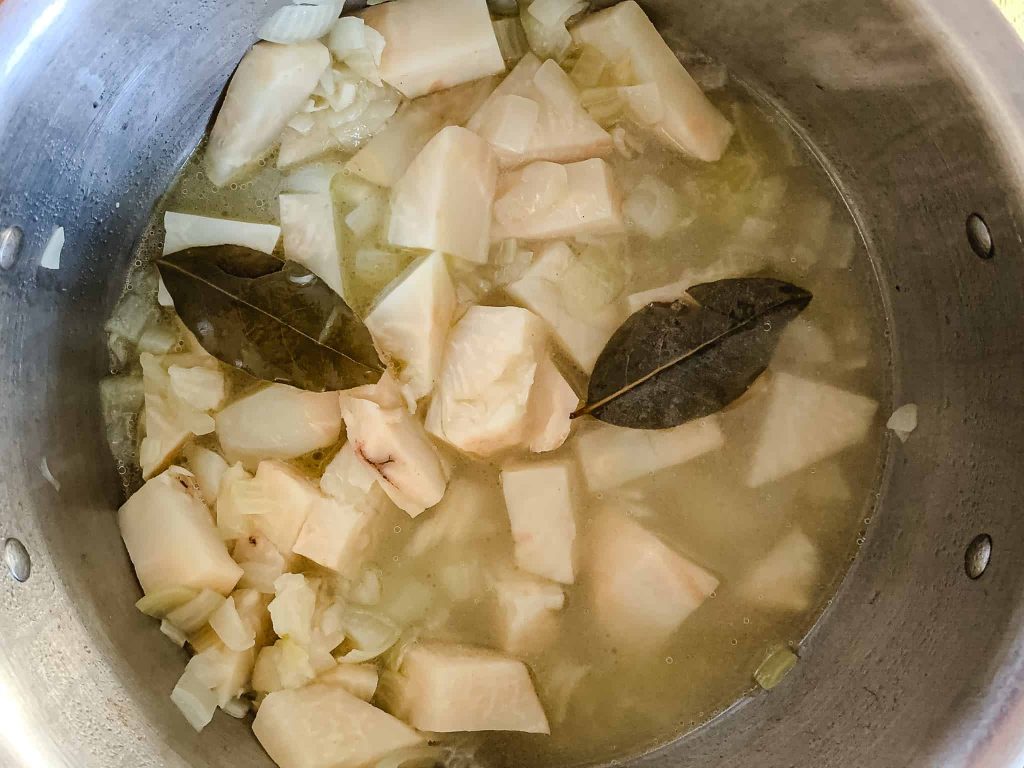 celery root soup simmering in a pot