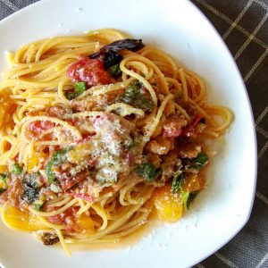 A plate of summer spaghetti on a tablecloth