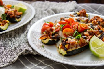 Turkey taco stuffed zucchini boats on a plate