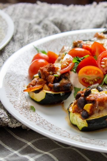 Turkey taco stuffed zucchini boats on a plate
