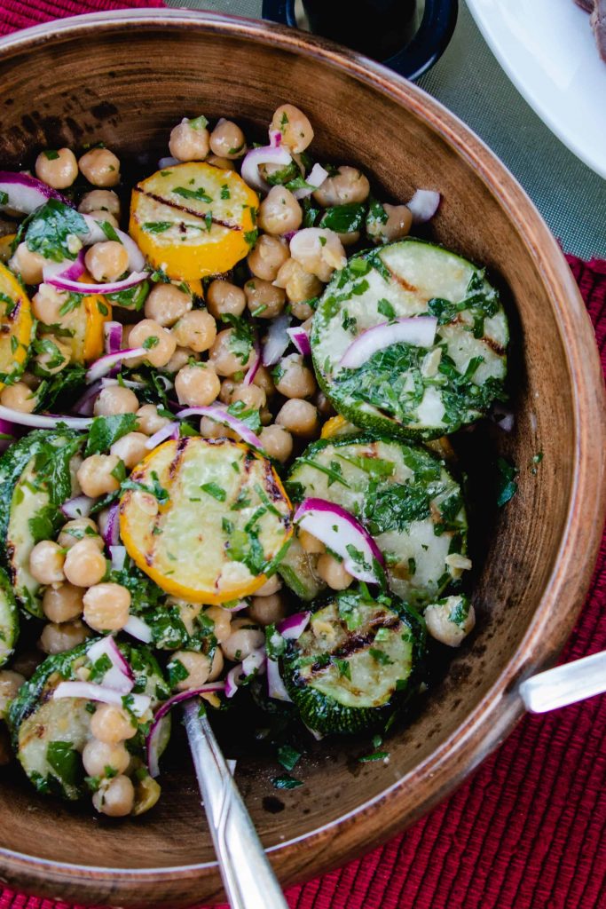 zucchini and chickpea salad in a wooden bowl. 