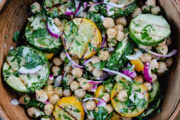 A delicious looking bowl of grilled zucchini and chickpea salad with red onions