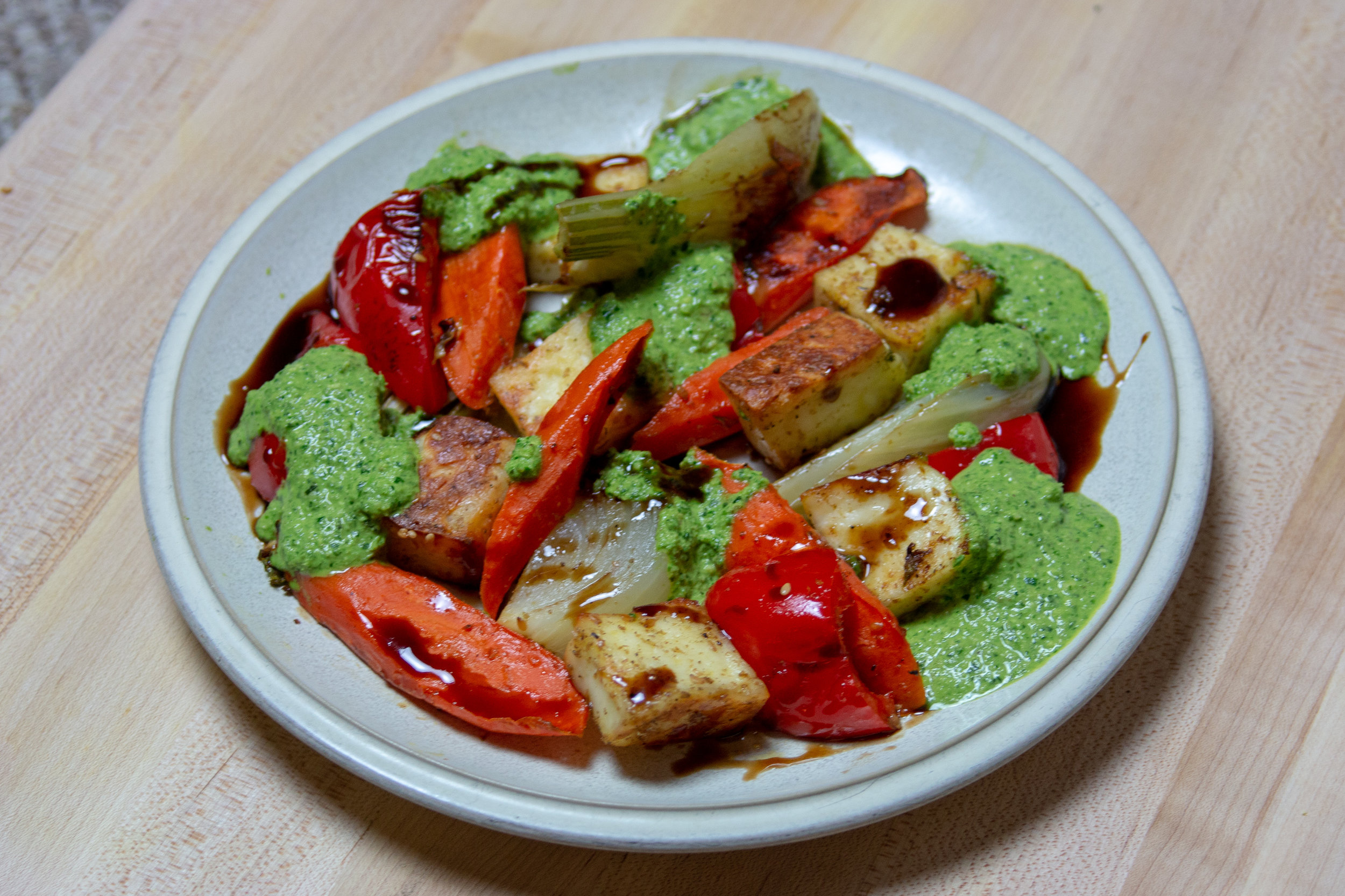  Roasted veggies and cubed paneer with spinach walnut pesto and pomegranate molasses. 