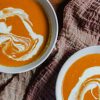 Two bowls of spiced tomato and coconut soup