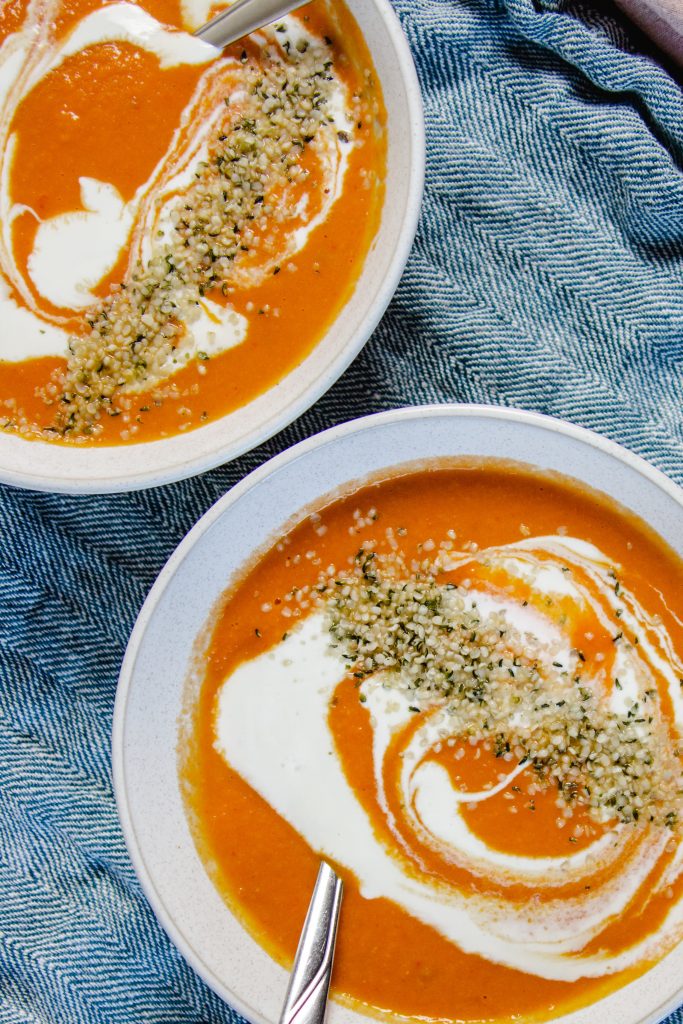 two bowls of tomato coconut soup.