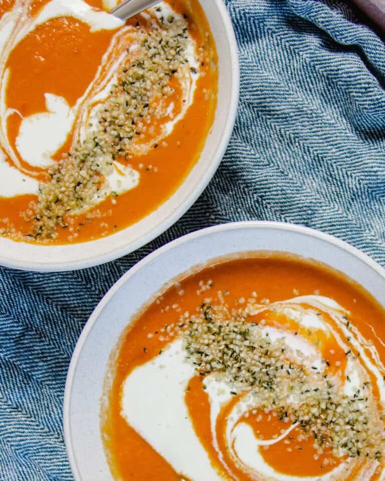two bowls of tomato coconut soup.