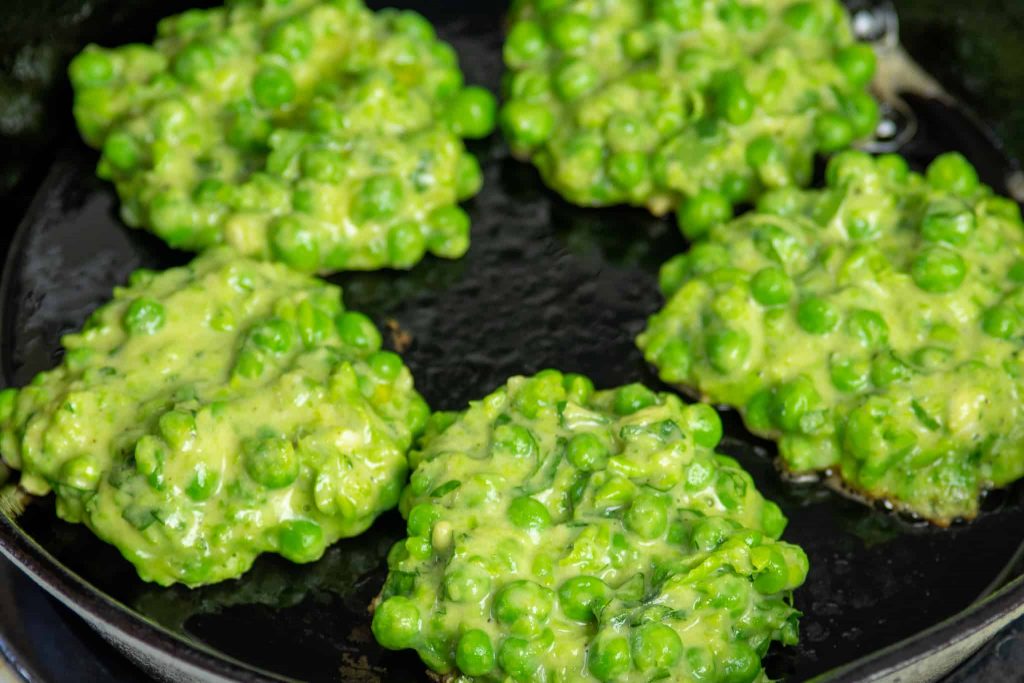 green-pea-fritters-frying-in-cast-iron-pan