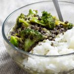 a bowl of black lentil and broccoli curry over steamed jasmine rice
