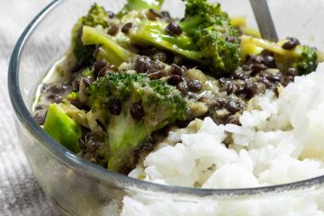 a bowl of black lentil and broccoli curry over steamed jasmine rice