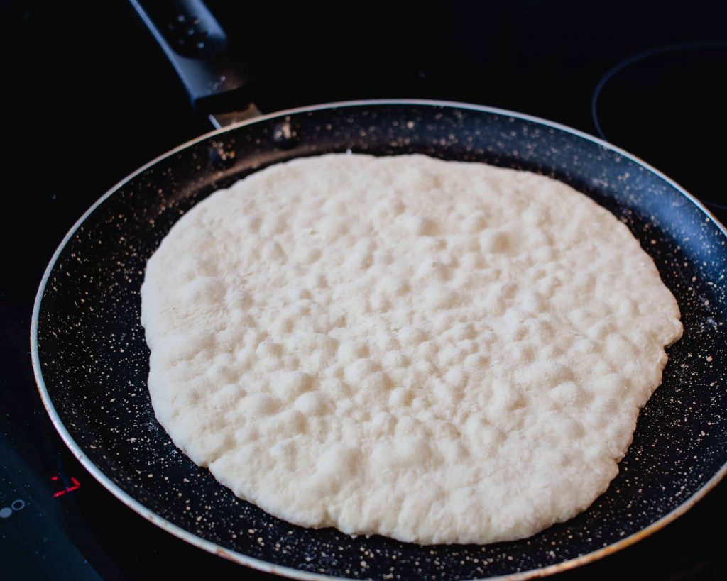 Flatbread frying in a pan.
