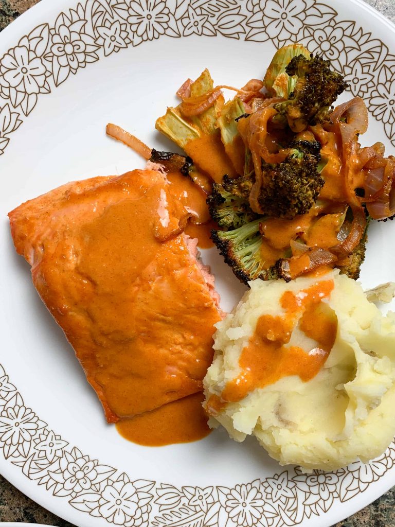 roasted broccoli, salmon, and mashed potatoes on a plate