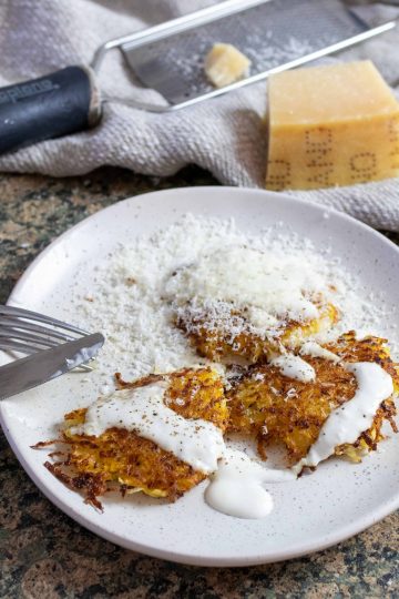 rutabaga latkes with parmesan cheese on a plate