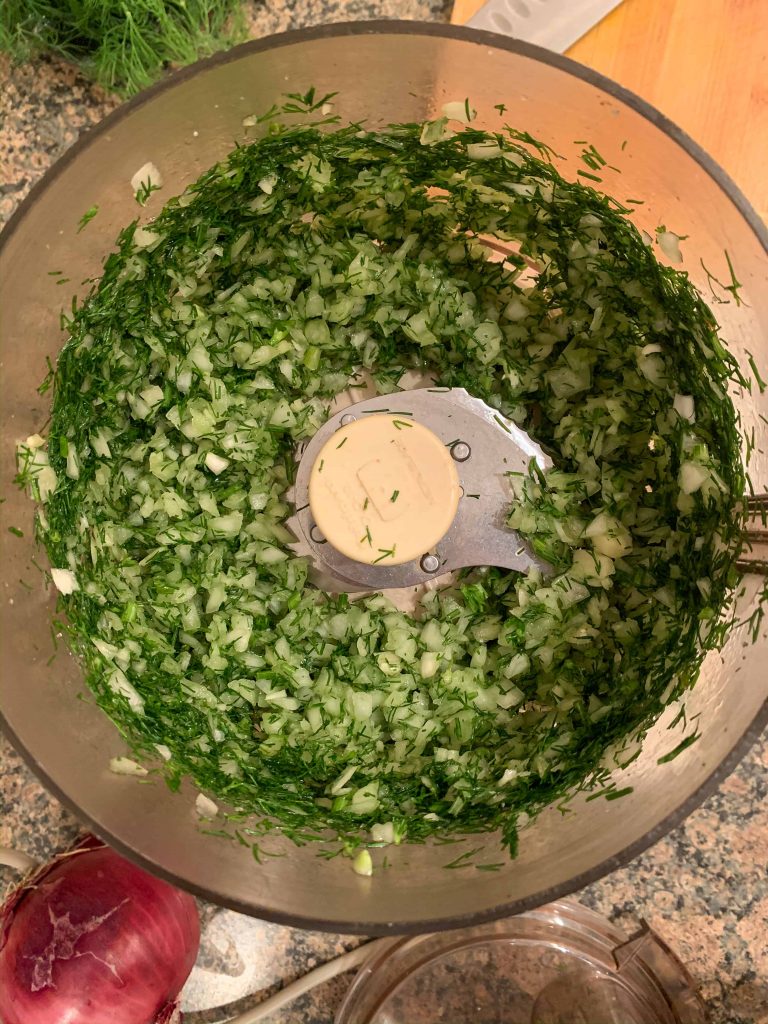 dill, onions, and garlic in a food processor.
