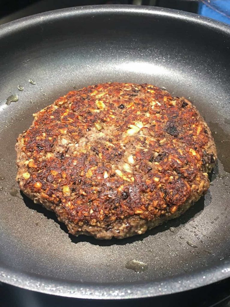 gluten-free mushroom burger patty cooking.