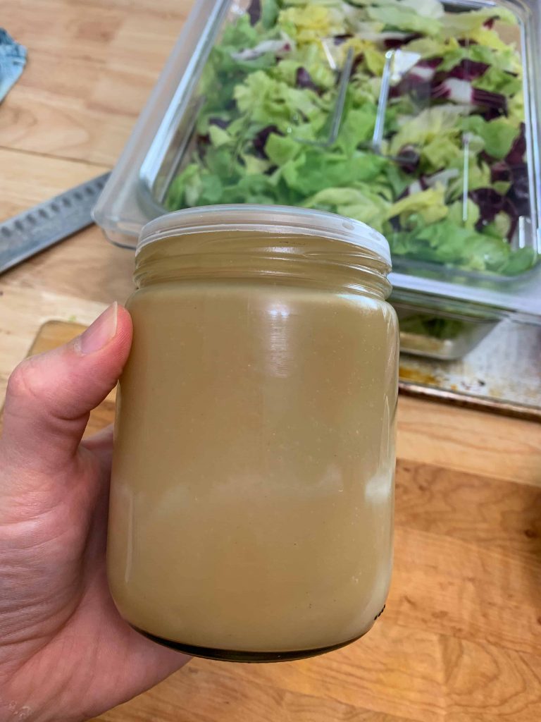 a jar of creamy balsamic dressing for salad.