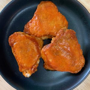 a plate of buffalo chicken thighs.