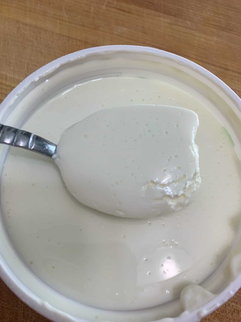 a scoop of sour cream from the tub.