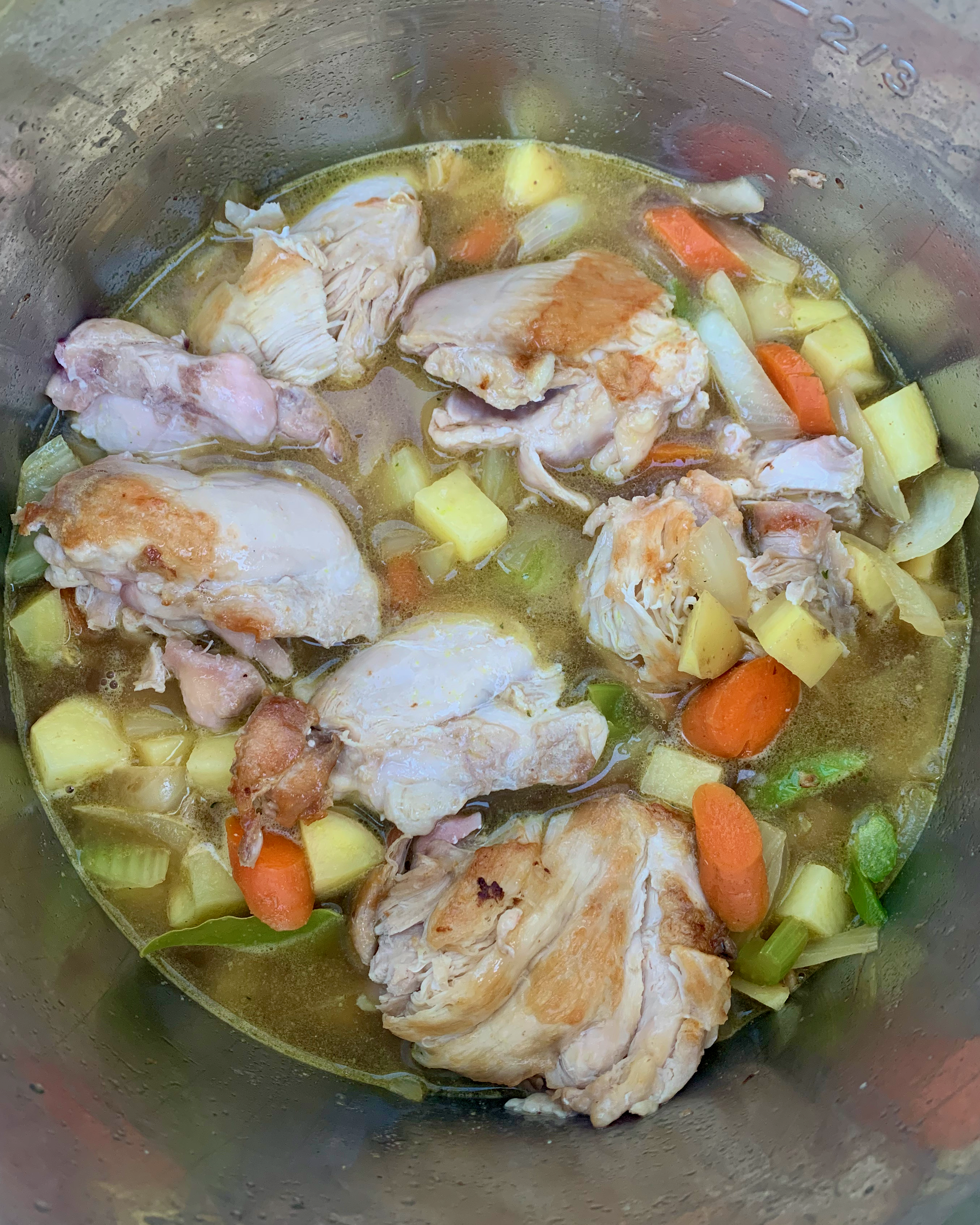 chicken stew ingredients in the Instant Pot, ready to pressure cook.