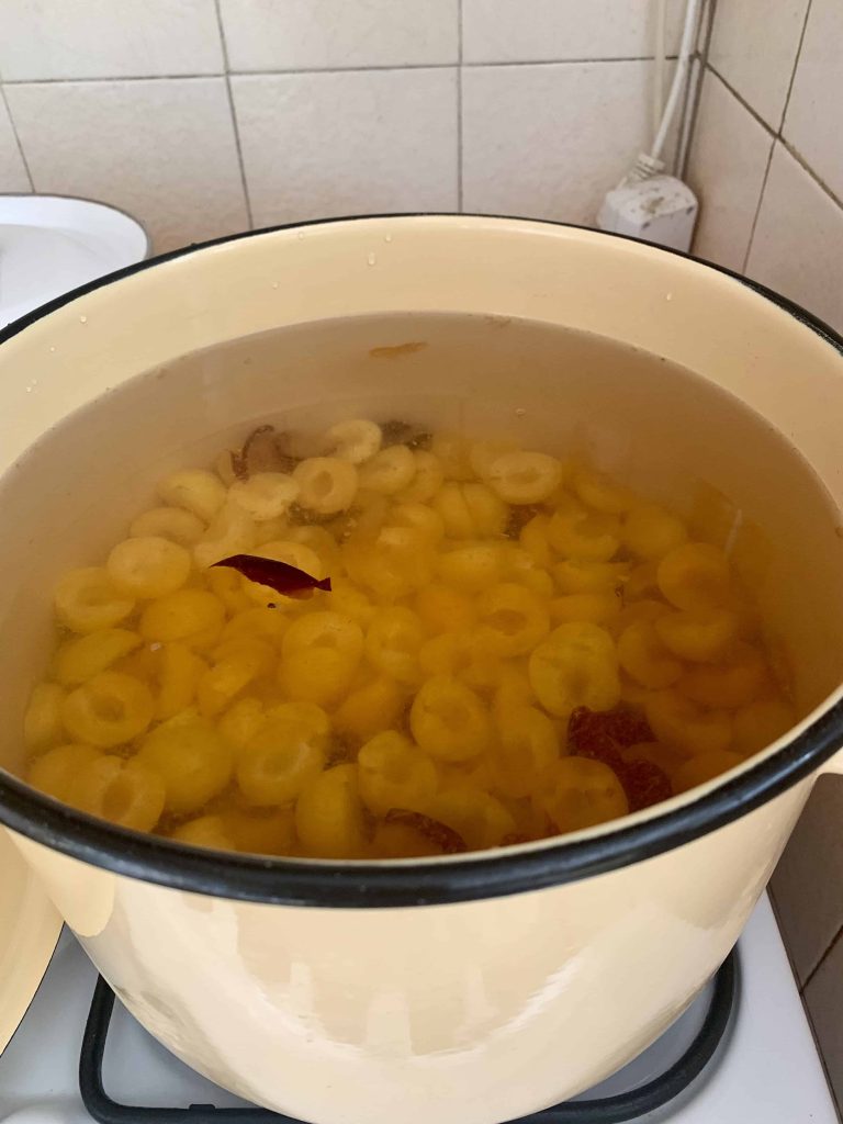 A large pot of kompot cooking on the stove.