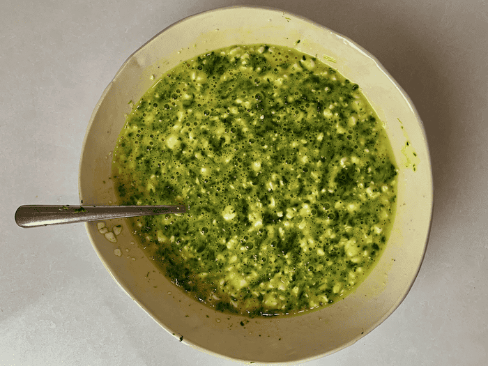 Egg, cottage cheese, and spinach mixture, ready to add to the pan.