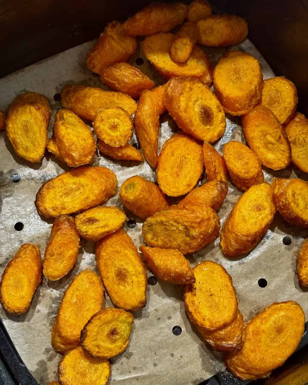 Golden fried banana slices on a baking sheet for a snack or dessert.