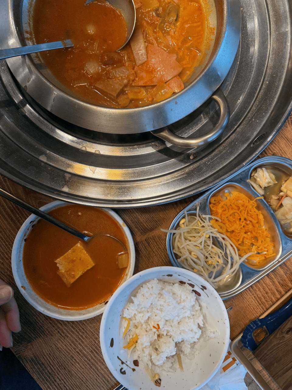 A pot of army stew along with rice and banchan at a restaurant in Seoul.