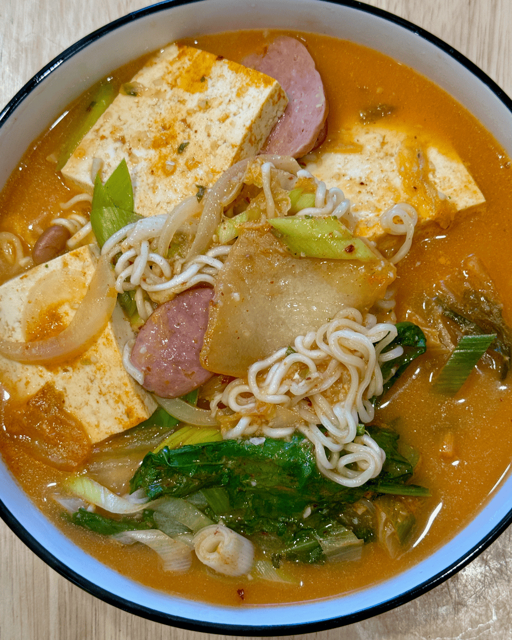 Army stew in a white bowl.