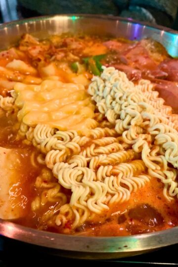 A large pot of army stew cooking.