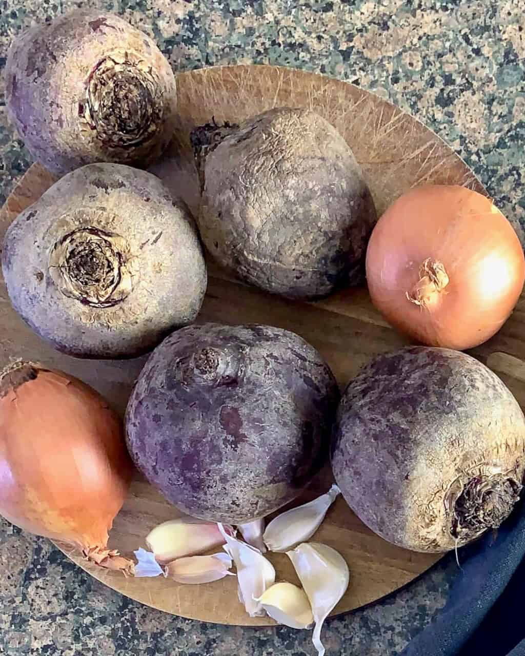 beets and onions on a cutting board.