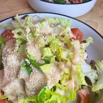 Image of a fully loaded cheeseburger bowl.