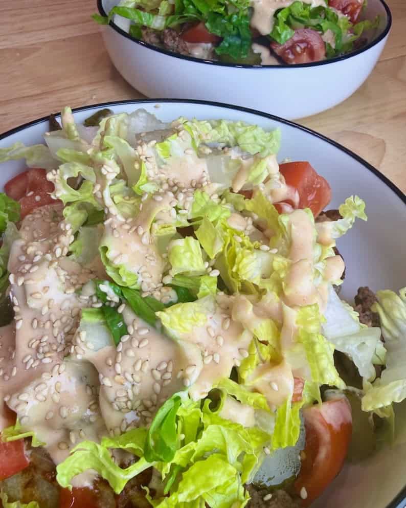 Image of a fully loaded cheeseburger bowl.