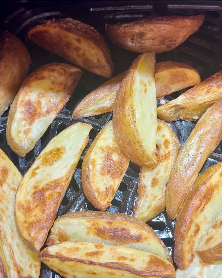 The finished wedge fries in the air fryer.