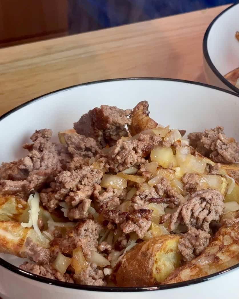 Adding the ground beef to the bowl.