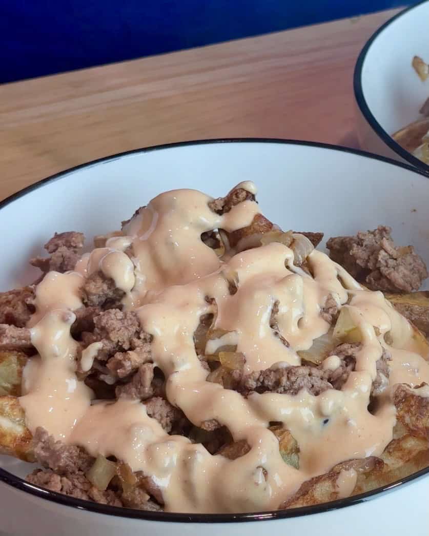 Adding burger sauce to the burger bowl.