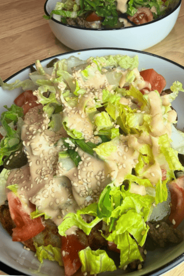 Image of a fully loaded cheeseburger bowl.