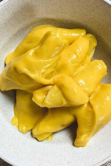 Close up of cheesy butternut squash pasta in a bowl.