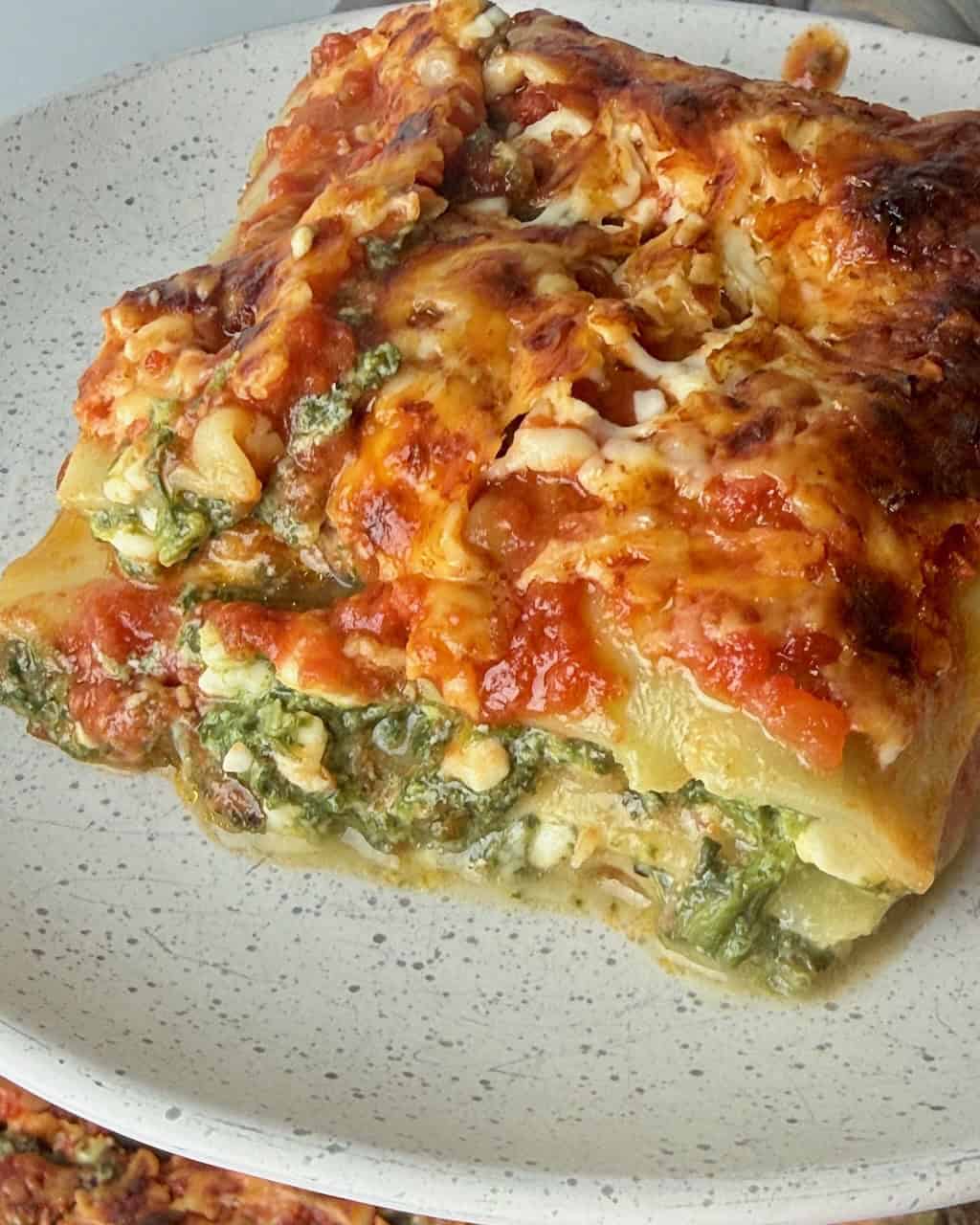 A slice of lasagna on a plate, ready to enjoy.