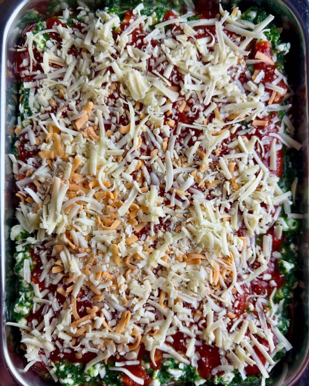 Layering the lasagna - cheese sprinkled on top