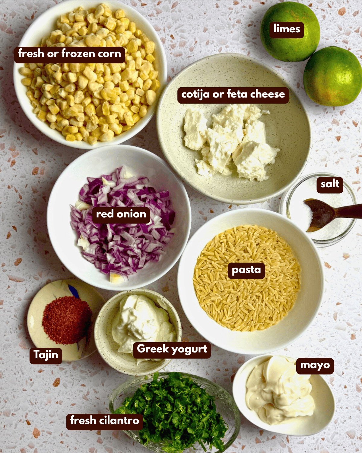 Ingredients needed for the elote pasta salad, laid out in bowls.