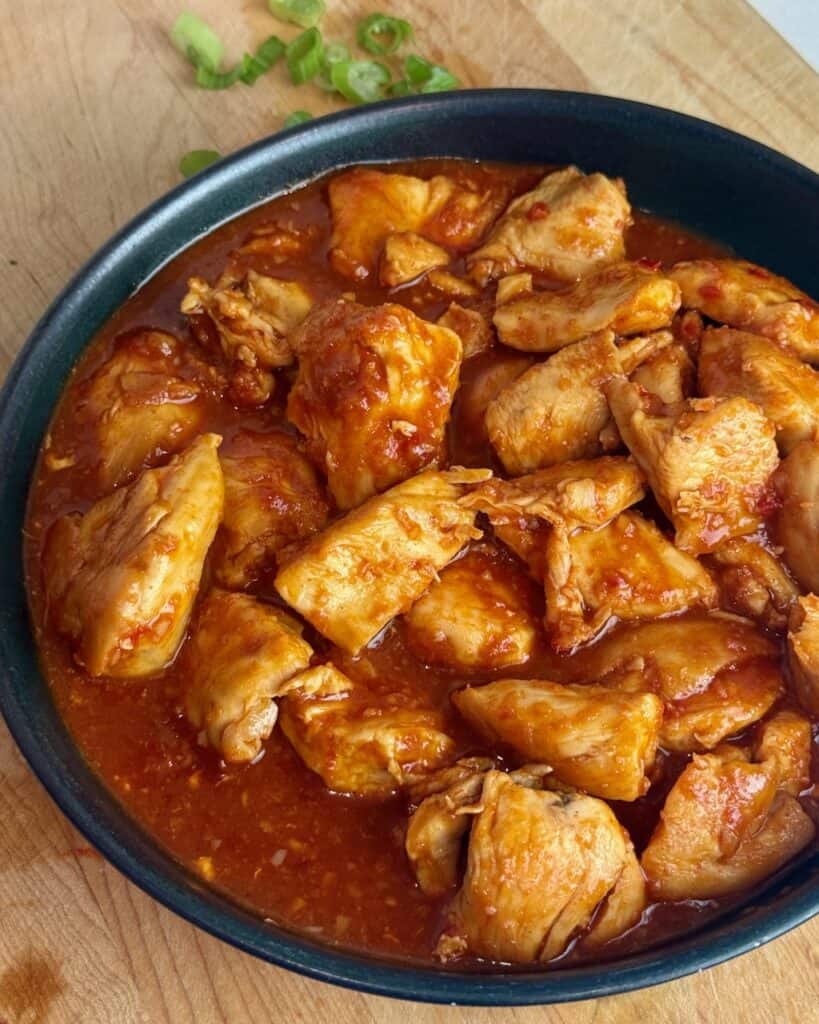 A plate of gochujang chicken before garnishing.