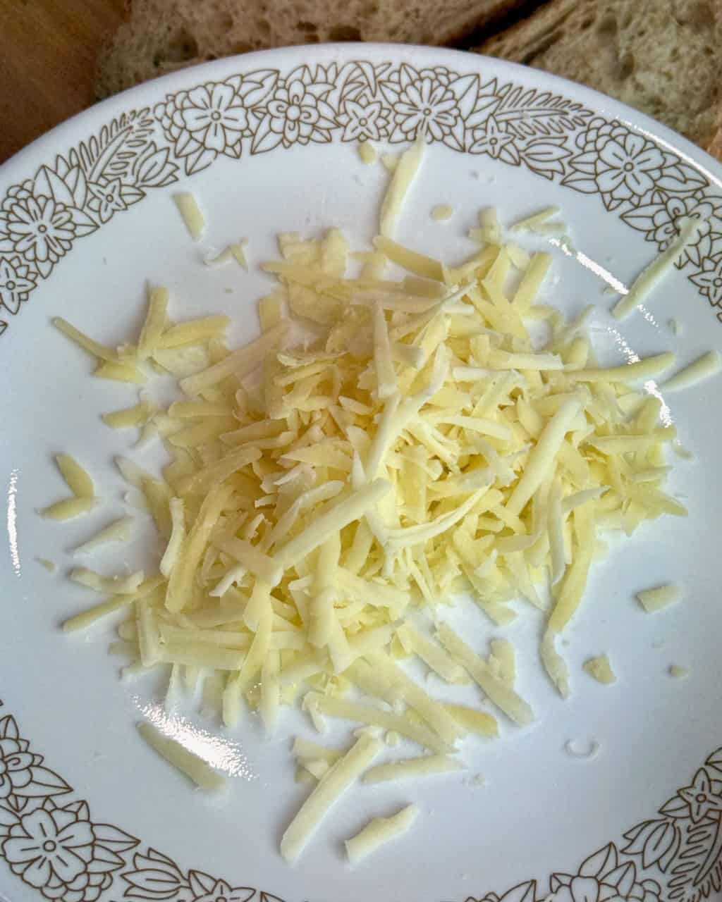 A pile of grated cheese on a plate.