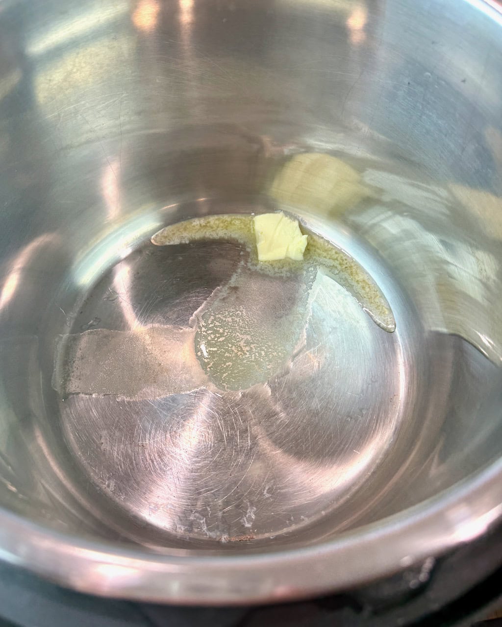 Melting a pat of butter in the Instant Pot.