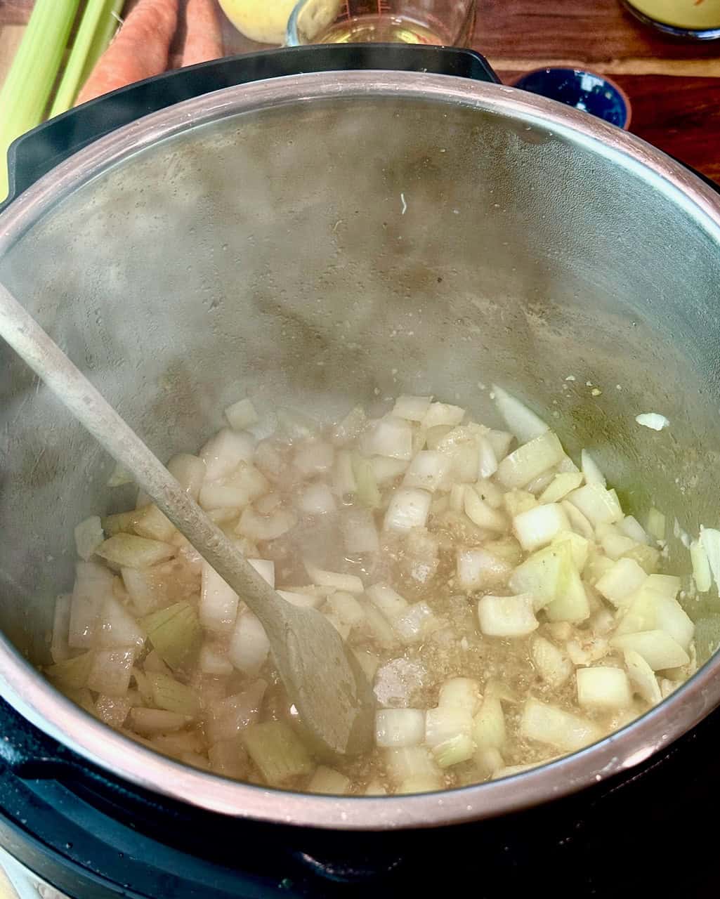 Onions and garlic in the instant pot, deglazed with white wine.