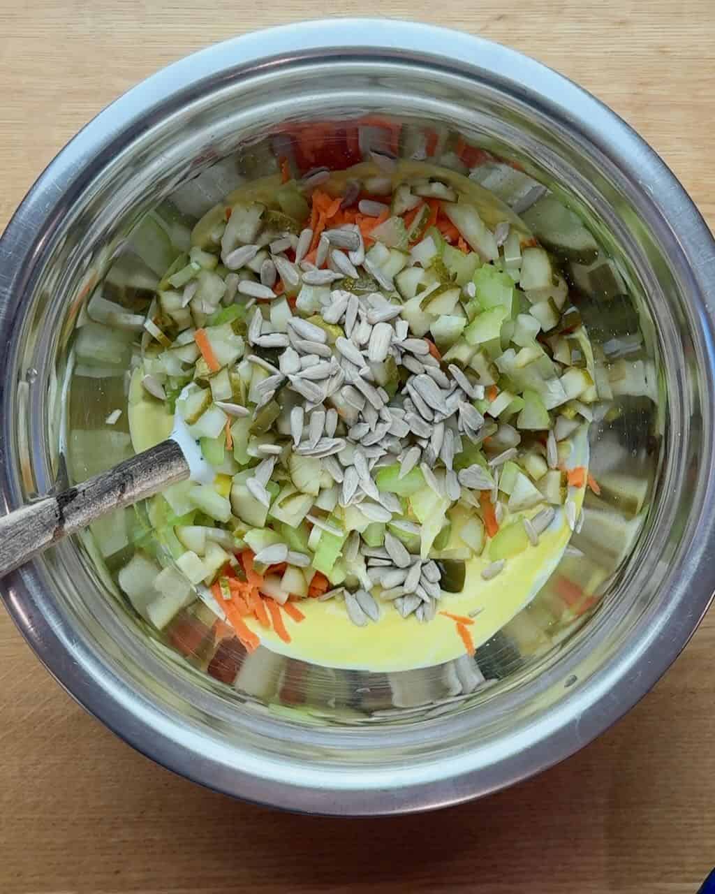 Potato salad ingredients in a stainless steel bowl, ready to be mixed.