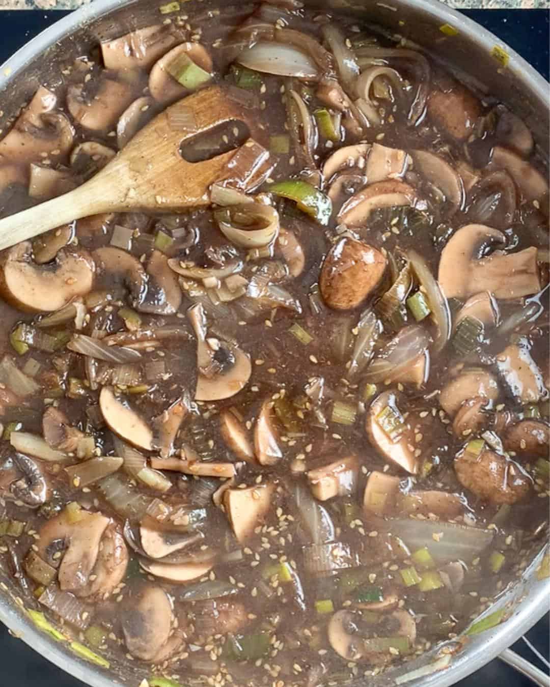 Mushroom pie filling cooking in a pan.