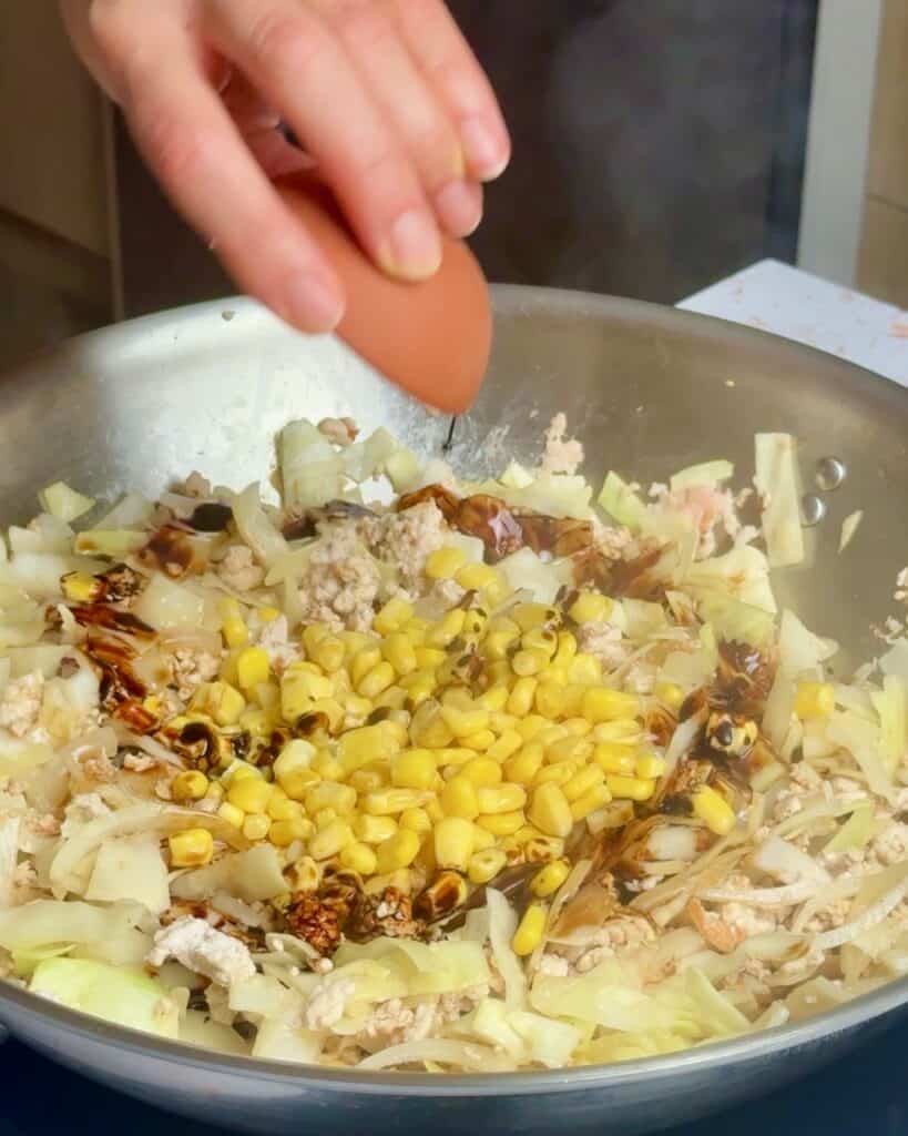 Adding all the liquid seasonings to the stir fry to create the sauce.