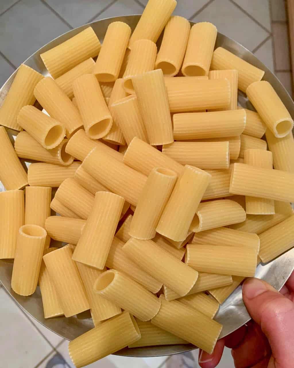 Raw tubes of rigatoni pasta ready to be boiled.